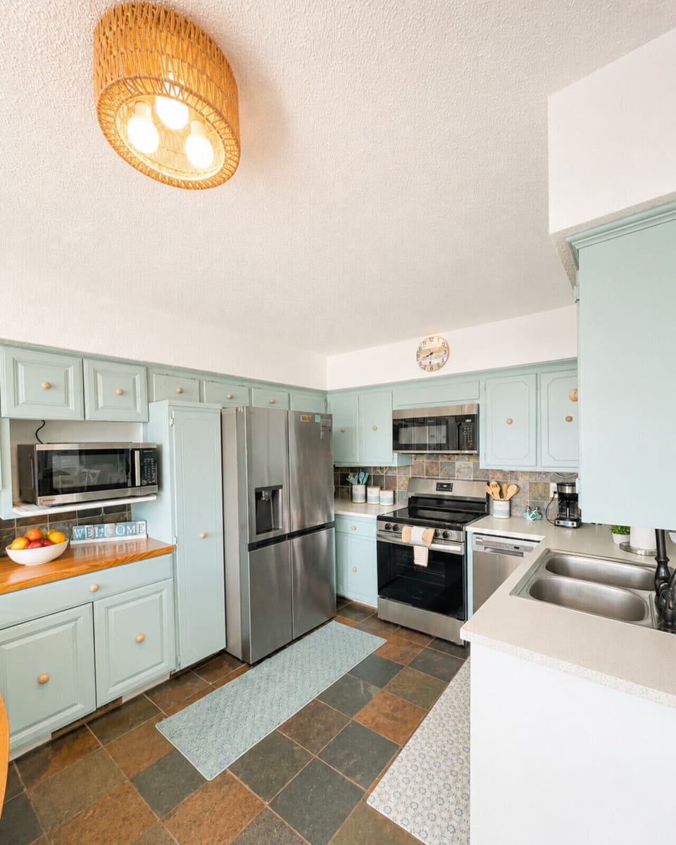 Bright, fully equipped lake house kitchen with modern appliances and coastal charm—perfect for family vacations and relaxing weekend getaways.