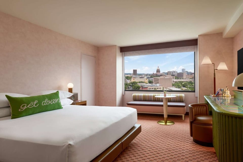 King bed room with window seat and city view