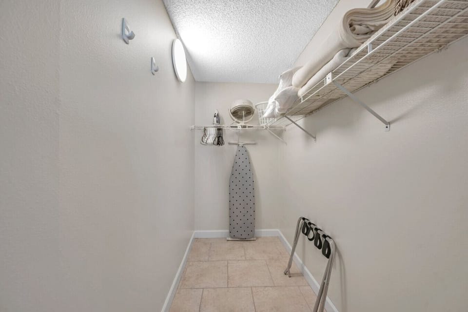 Walk-in closet w/ hanging space and shelves to keep everything organized.