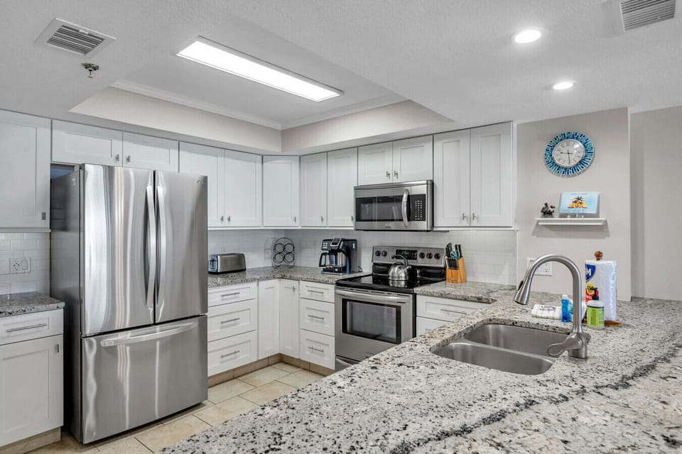 Bright kitchen w/ stainless appliances & ample counter space for meal prep.