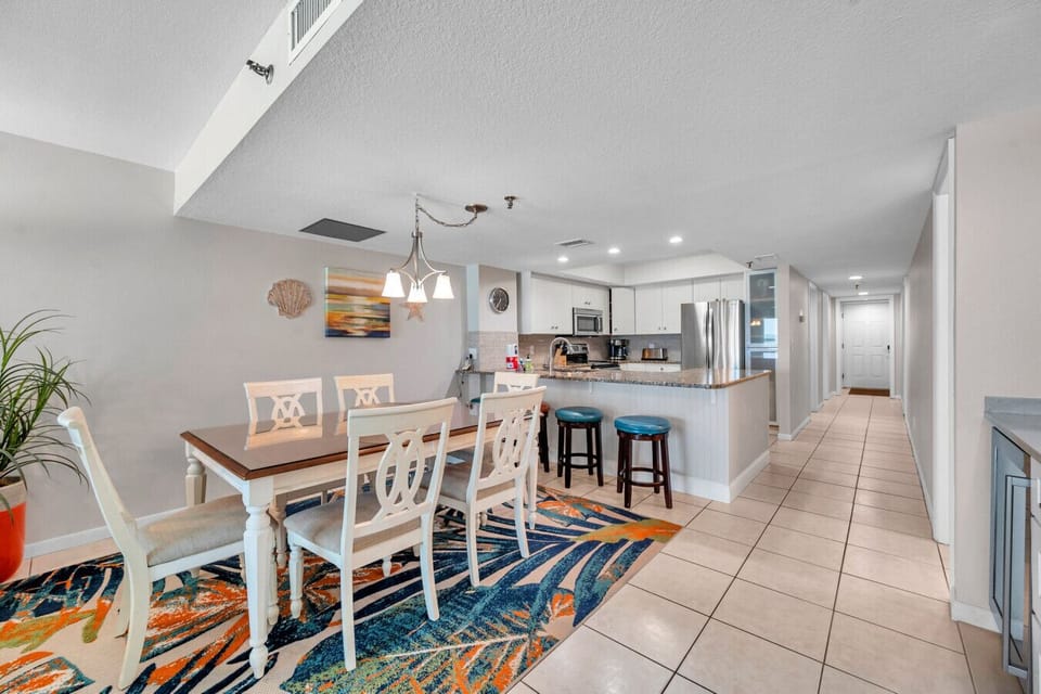 Open dining area w/ a spacious table, flowing seamlessly into the kitchen for easy gatherings.