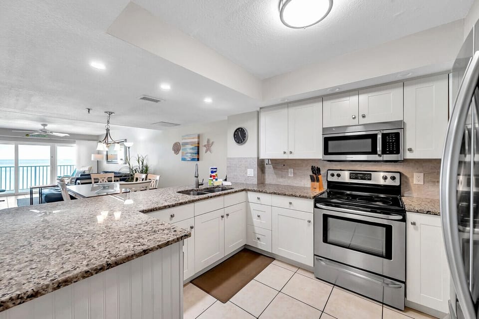 Fully equipped kitchen w/ granite counters, ample prep space, and room to cook together.