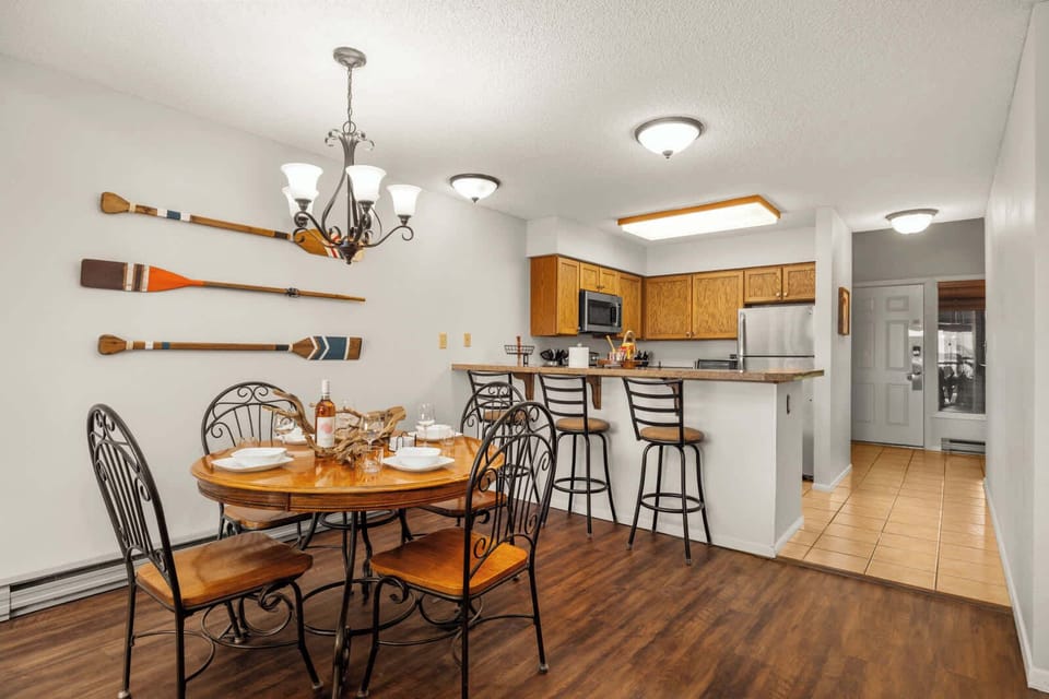 Gather around for meals or game night in the cozy dining nook with lake cabin charm.