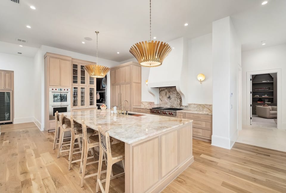 Your dream kitchen awaits with marble countertops, custom cabinetry, and elegant lighting that makes cooking feel like pure luxury.