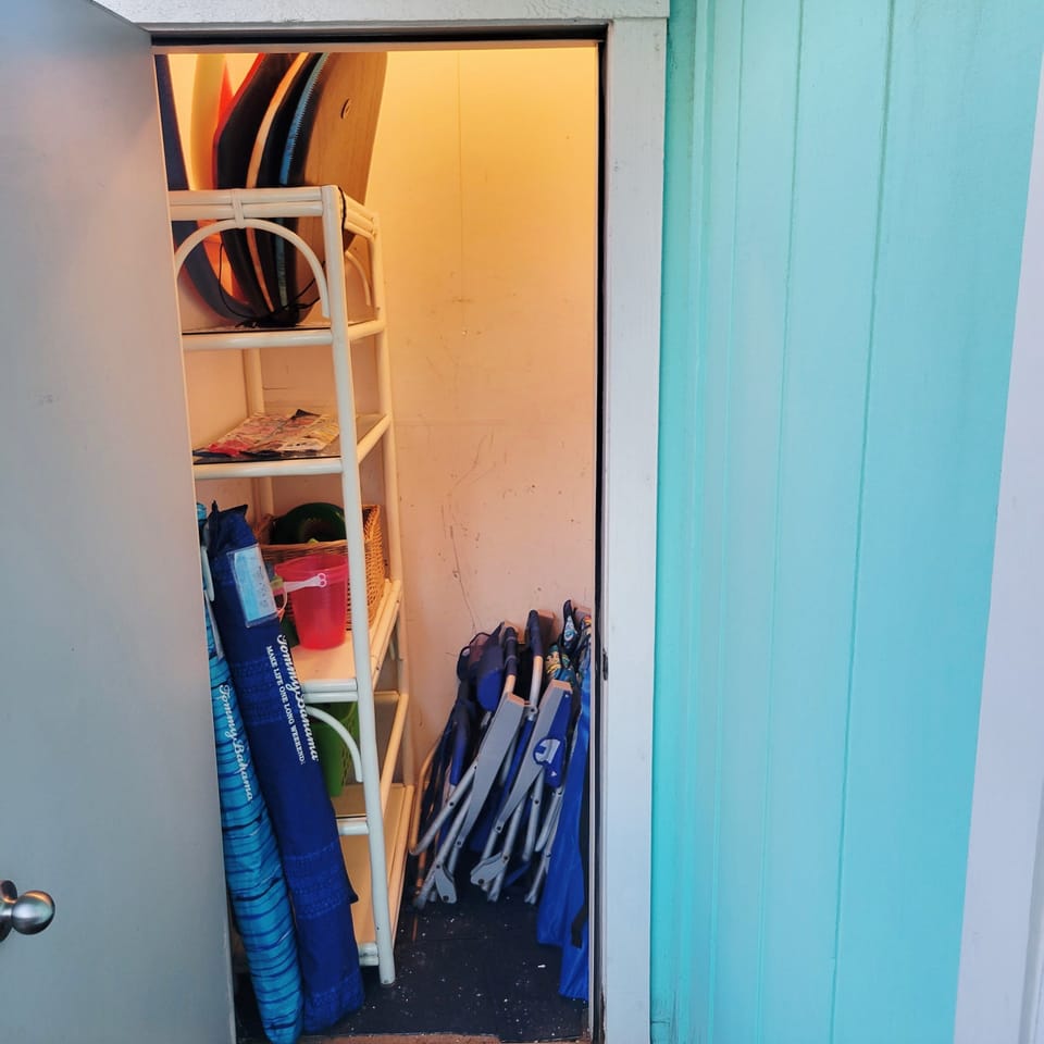 Storage closet off the back deck with beach accessories for your enjoyment. 