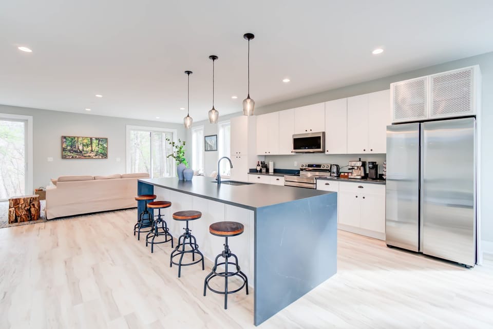 Fully equipped and designed for comfort, this cozy kitchen with an island table is perfect for cooking and conversation.