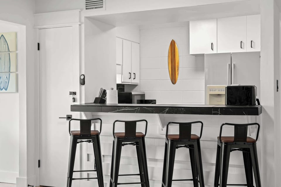 The breakfast bar with four barstools offers a cozy spot for dining...