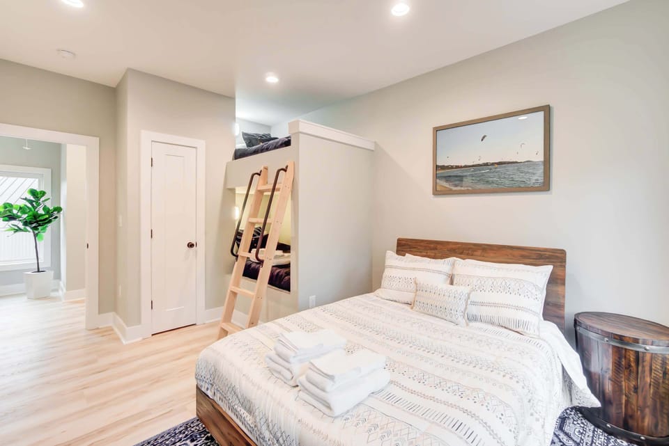 A charming kids' room with a full-size bed and twin-size bed, where natural light pours in through the glass window.