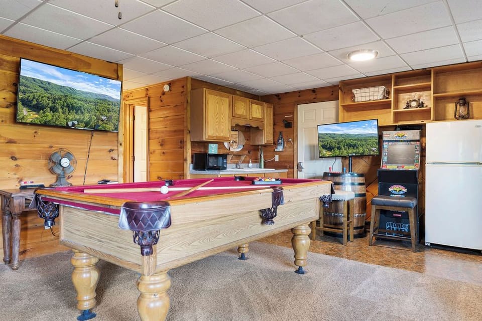 Fun game room with pool table, arcade games, and comfy seating!