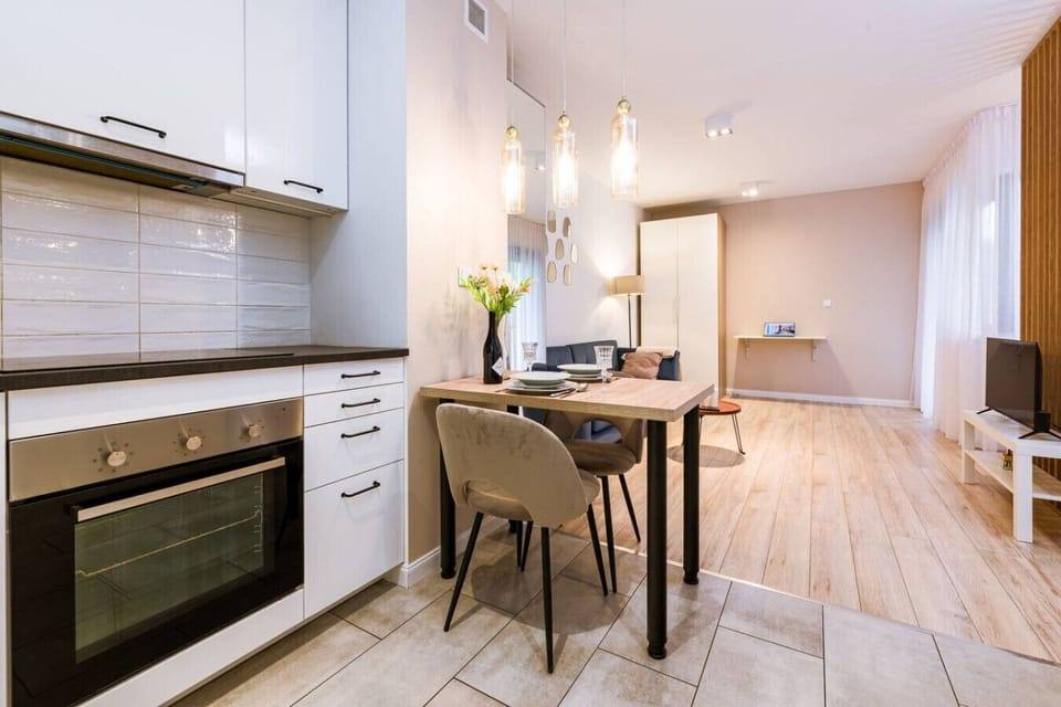 Living Area witha Sofa Bed, Smart TV and Dining Table | Book Now with RENTUJEMY.COM