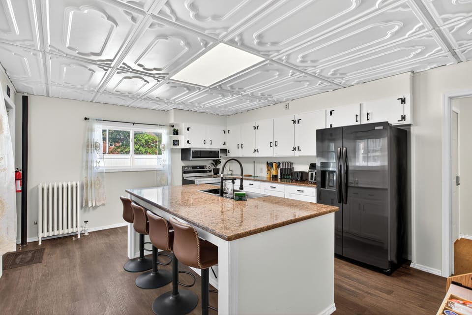 Cook in a modern, fully equipped kitchen with a bright island seating four.