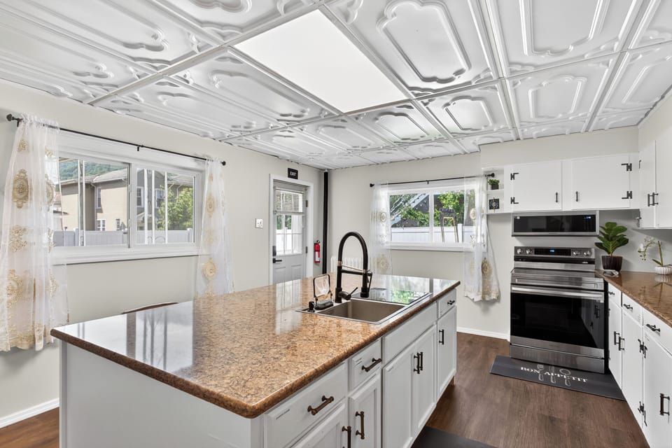 Cook easily in a fully equipped kitchen with modern appliances and island.