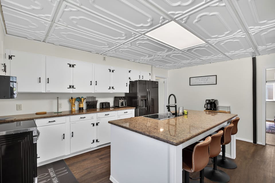 Chef’s kitchen with island, modern appliances & bar seating for gatherings.
