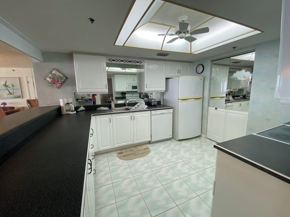 Fully equipped kitchen complete with dishes, utensils, cookware and appliances.