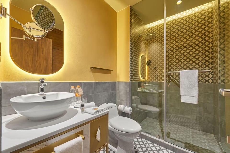Refresh under a glass shower with spa-like patterned tiles.