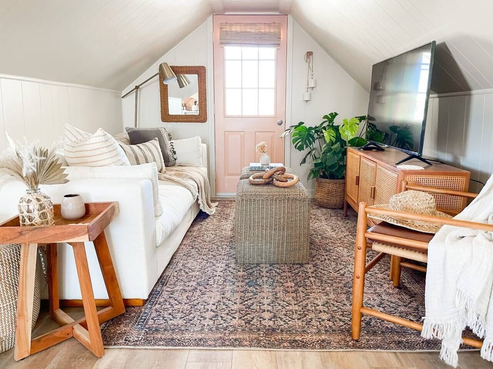 Cozy Living room perfect to cozy up and watch your favorite show after a day at the beach! even more cozy is the reading nook to the right of the living room with a second tv and a small daybed.  