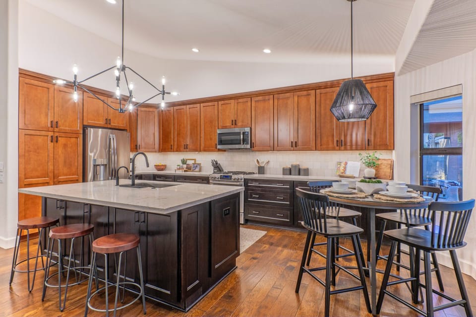 Kitchen with island and table seating has everything your chef needs to prep and serve healthy, home cooked meals.