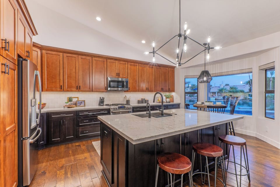 Modern and completely stocked kitchen has island and table seating.