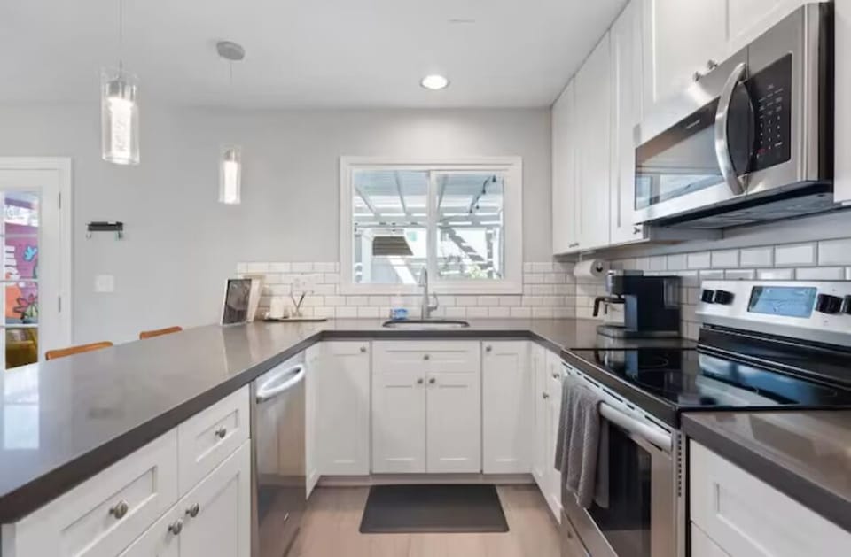 Bar seating at kitchen island in sleek, modern, and open-plan kitchen
