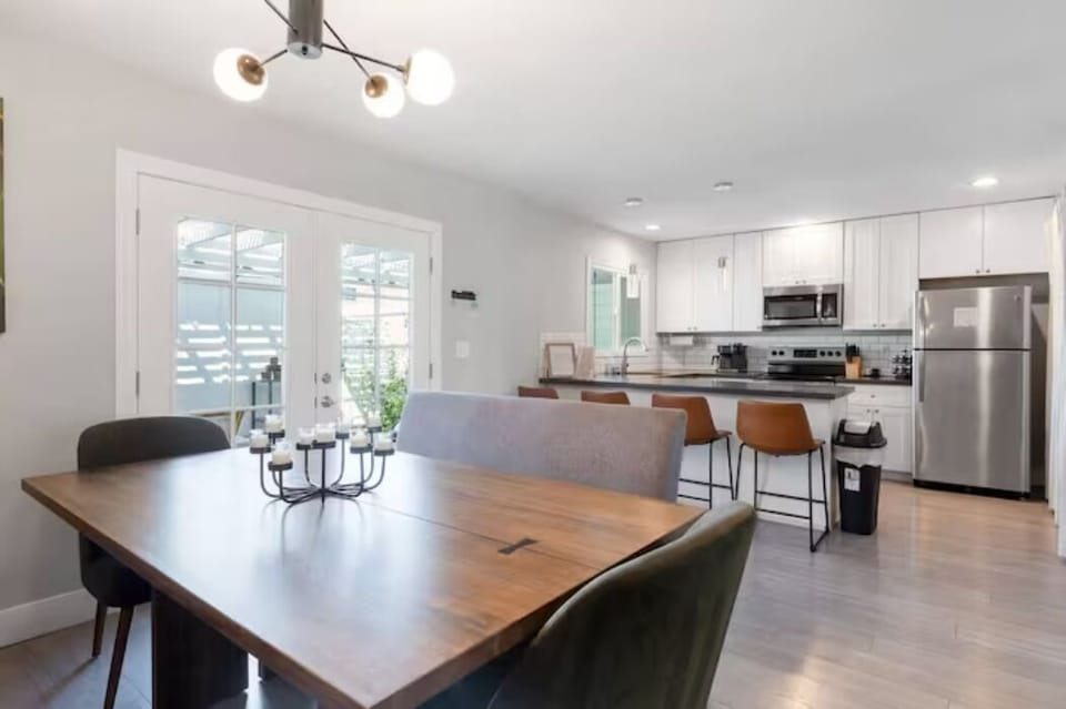 U-shaped kitchen with deep sink, sleek counters, and stainless appliances

