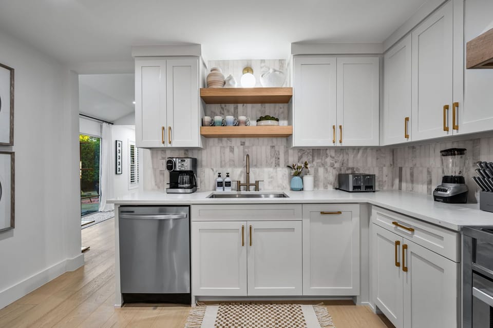 Stylish kitchen for entertaining! Small kitchen appliances include toaster, blender, crockpot, combo K-cup and regular pot coffee maker, and electric tea kettle.