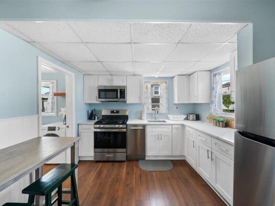 Bright, beachy, and fully stocked—this modern kitchen is ready for your morning coffee or a seafood dinner in.
