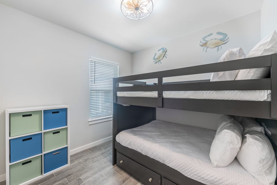 Your kids will love this playful bunk bed room with cheerful sea-themed decor and plenty of storage for their treasures.