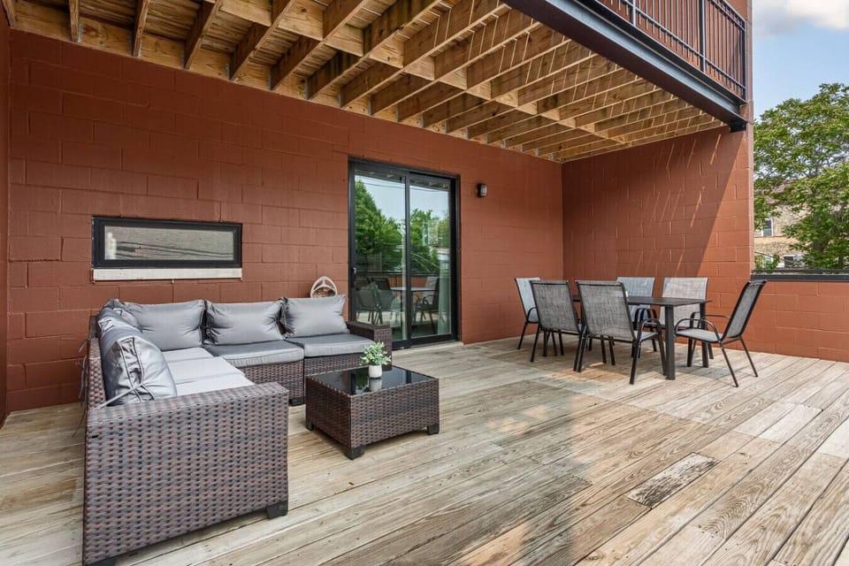 Large private outdoor balcony with table for 6 and sectional sofa seating