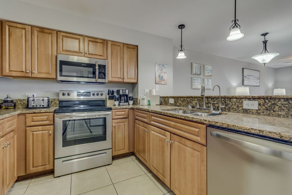 Cook your favorite meals in this fully equipped kitchen with granite countertops, stainless steel appliances, and ample cabinet space for all your culinary needs.