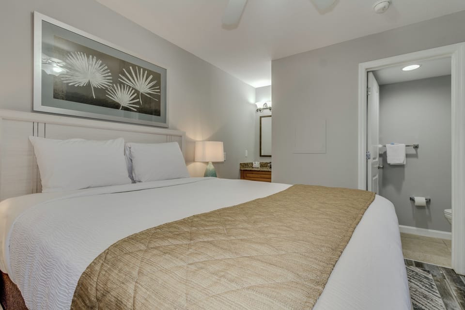 Sink into crisp white linens and soft pillows in your peaceful bedroom retreat, with an ensuite bathroom just steps away.