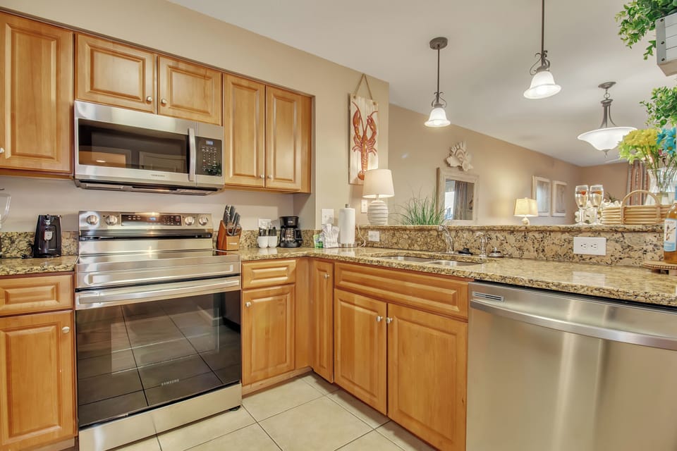 Your fully equipped kitchen features granite counters, stainless appliances, and warm wood cabinets—perfect for preparing meals during your stay.