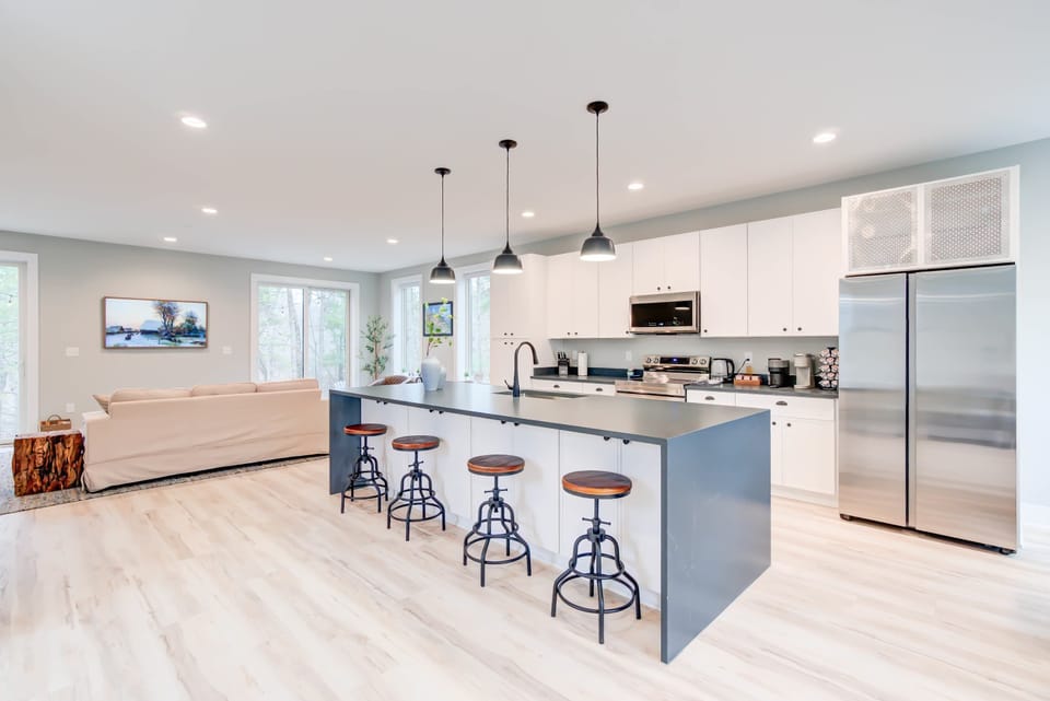 Fully equipped and designed for comfort, this cozy kitchen with an island table is perfect for cooking and conversation.