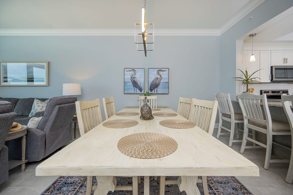 Dine together at the spacious table, surrounded by coastal decor and natural light, and enjoy memorable moments