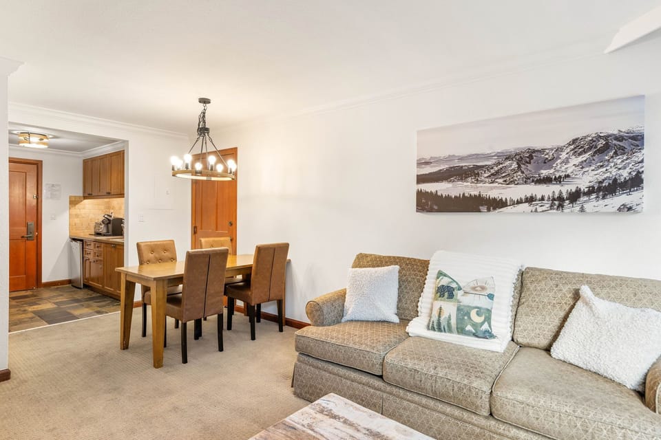 Relax in your open-concept living space with cozy seating, dining for six, and a fully equipped kitchen—perfect for memorable mountain getaways.