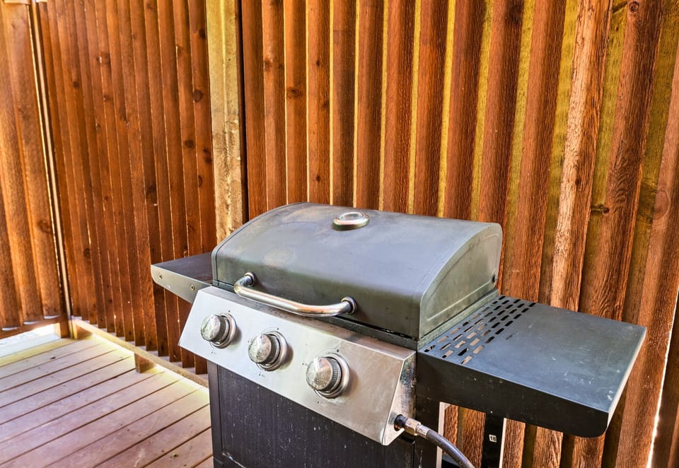 Fire up the gas grill on the covered deck—perfect for burgers, steaks, or whatever your getaway cravings call for.