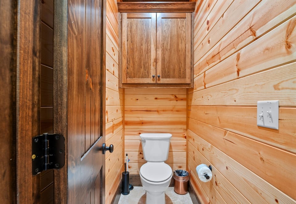 A private nook with everything you need—wood paneling, functional cabinetry, and thoughtful details make this powder room feel just right.