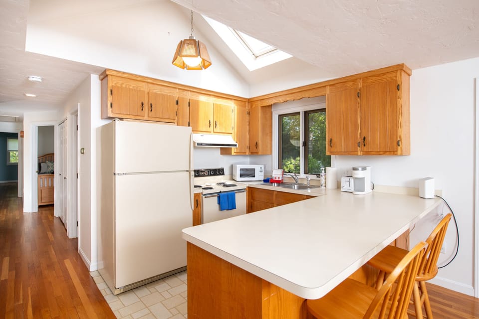 Fully equipped kitchen with vaulted ceilings and a central island for prepping or gathering.