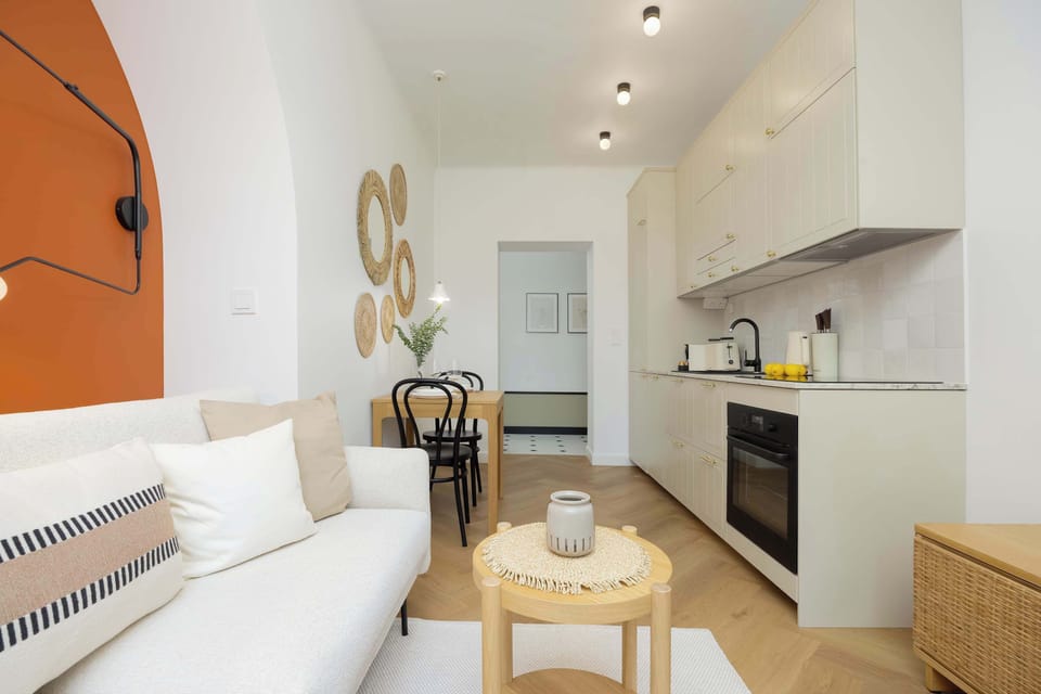A different view of the kitchen and dining area, highlighting the continuity of the orange accent wall.