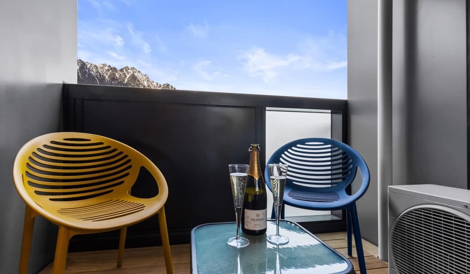 Sip and unwind with mountain views on your balcony.