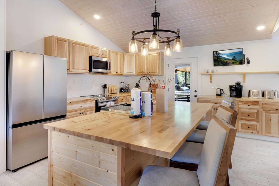 Modern kitchen with a large wooden island and stainless steel appliances