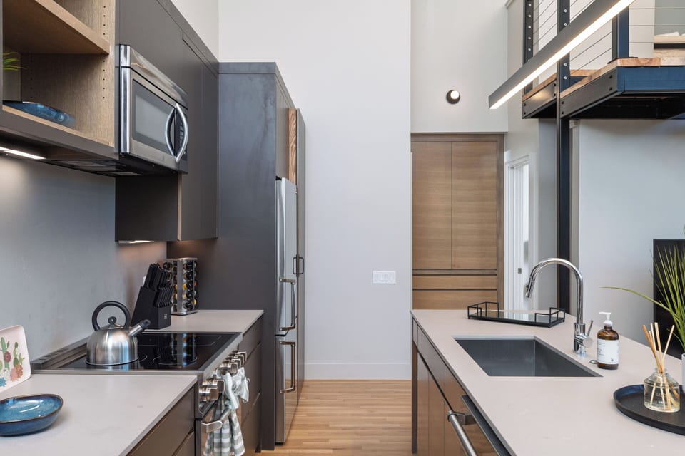 Kitchen is fully stocked and ready to use, with seating for 4 at the island.