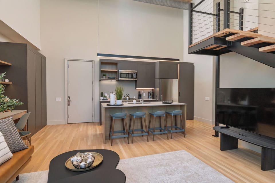 Kitchen is fully stocked and ready to use, with seating for 4 at the island.