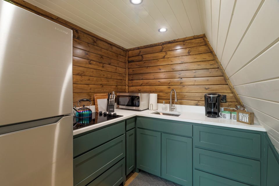 Refrigerator, stove top, microwave, keurig coffee maker with coffee and tea.  Pots and pans and all the necessary dishes needed