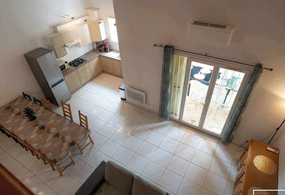 Large air-conditioned living room opening onto the fully equipped kitchen