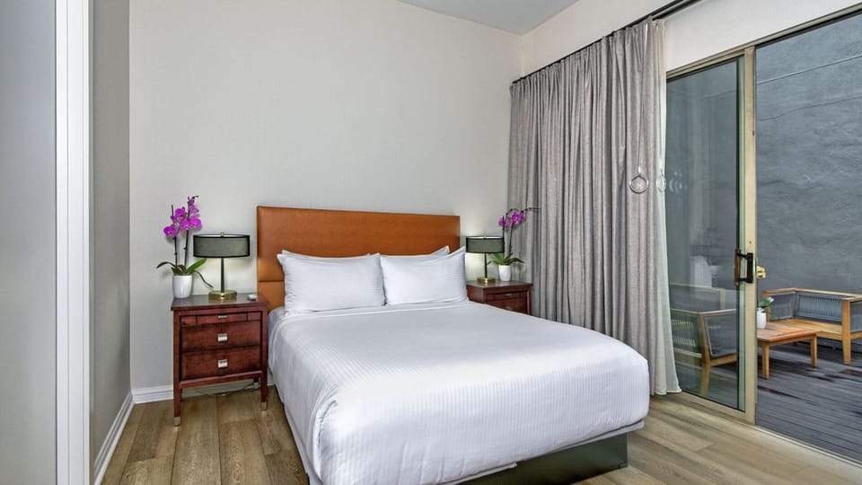 Unwind in crisp linens and step onto your private balcony.