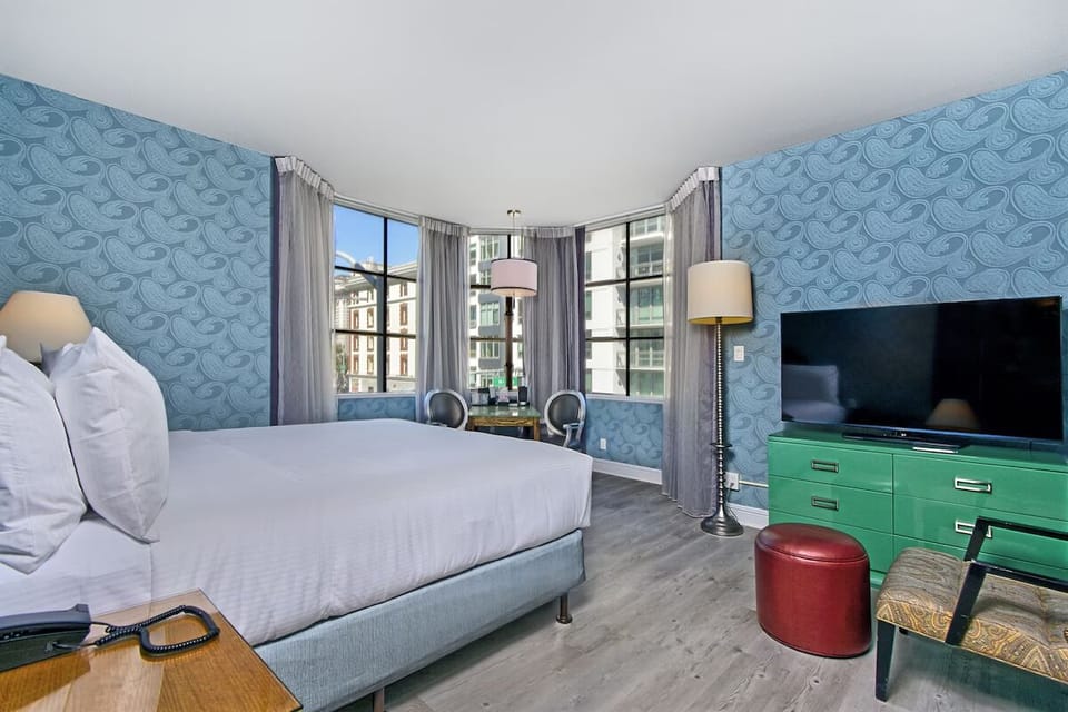Wake up to city light in a spacious, stylish bedroom retreat.