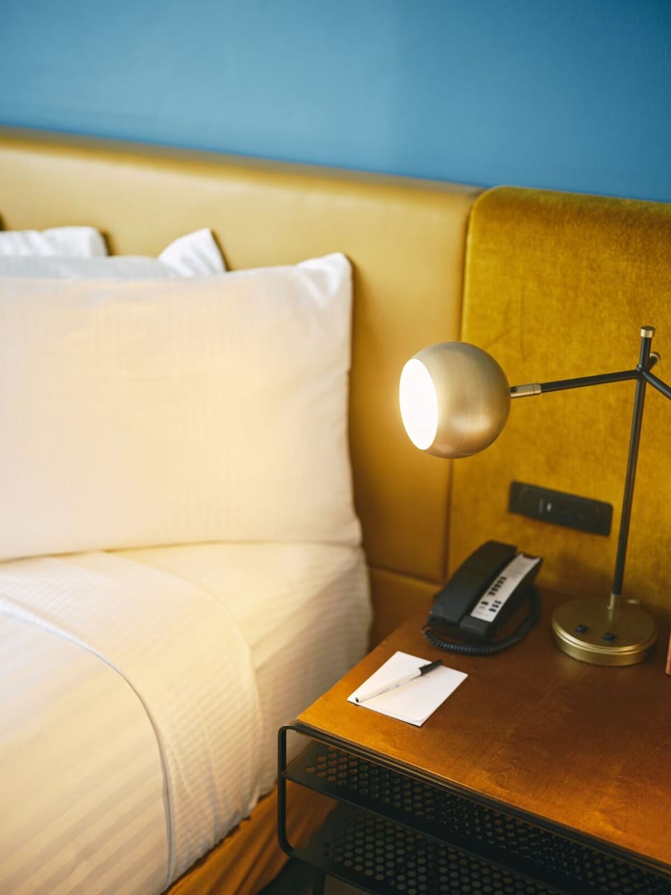 Enjoy bedside lighting and thoughtful touches for late-night reading.