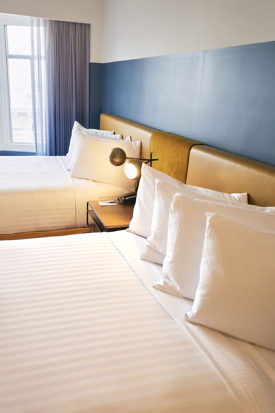 Share the space comfortably with two beds and soft lighting.