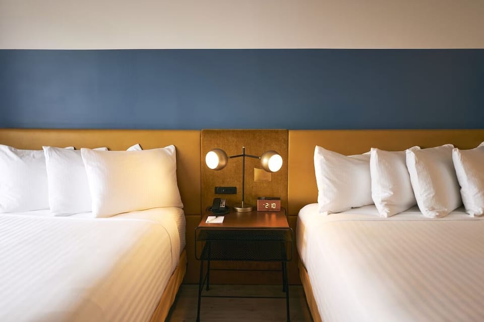 Drift off surrounded by crisp linens and calming designer tones.