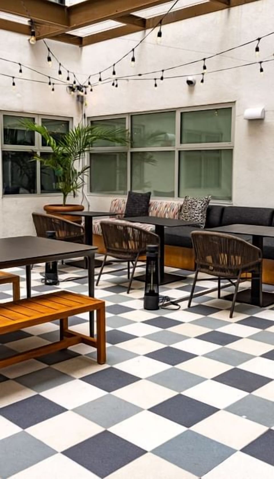 Linger outdoors under string lights in a breezy courtyard.